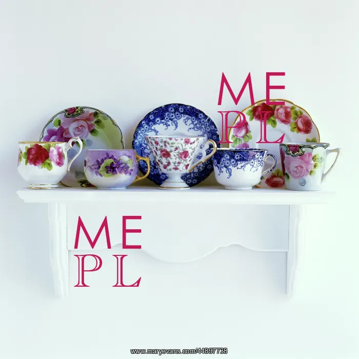 : FLORAL PATTERNED TEACUPS AND SAUCERS ON MANTELPIECE : FLORAL PATTERNED TEACUPS AND SAUCERS ON MANTELPIECE