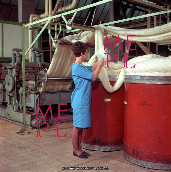 : Folding raw wool into large bins : Folding raw wool into large bins