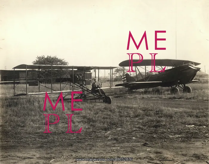 : Foreground: A replica of a 1912-style Curtiss pusher : Foreground: A replica of a 1912-style Curtiss pusher