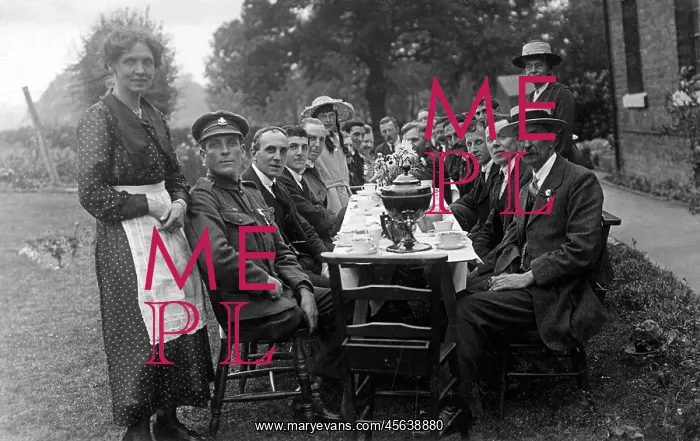 : Formal outdoor tea party at a long table : Formal outdoor tea party at a long table
