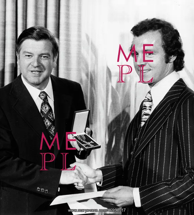 : Franz Beckenbauer receiving an award : Franz Beckenbauer receiving an award