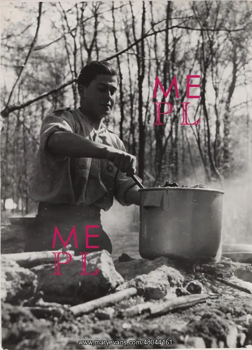: French boy scout cooking at camp : French boy scout cooking at camp