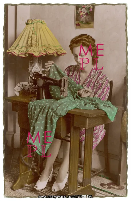 : French woman sewing with a Singer machine : French woman sewing with a Singer machine