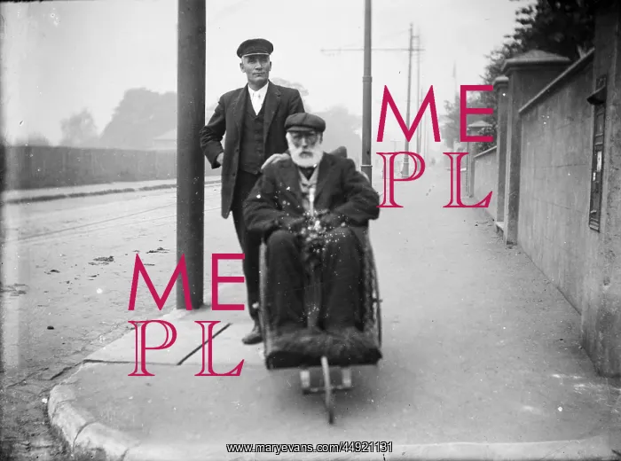 : Two gentlemen, one in wheelchair : Two gentlemen, one in wheelchair