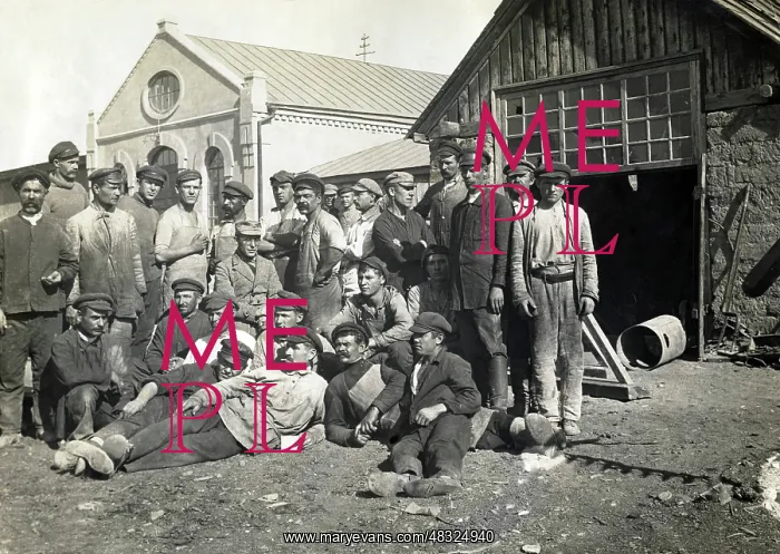 : German engineer with his workers in a large : German engineer with his workers in a large