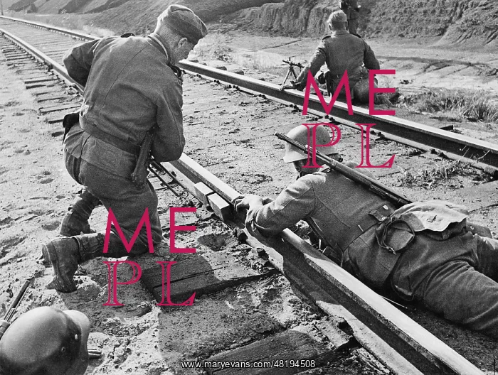 : German engineers remove an explosive charge from railway tra : German engineers remove an explosive charge from railway tra
