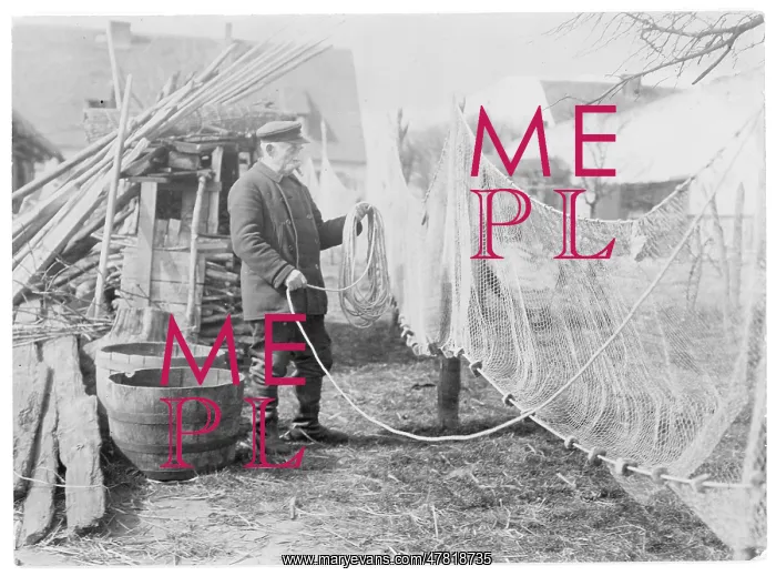  : A German fisherman mending his nets