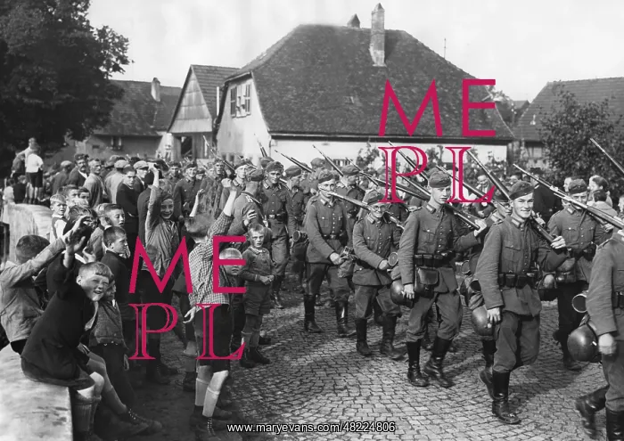 : German infantry marches through a village during a maneu : German infantry marches through a village during a maneu