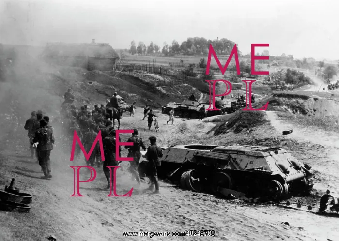: German infantrymen go past downed tanks, 1941 : German infantrymen go past downed tanks, 1941