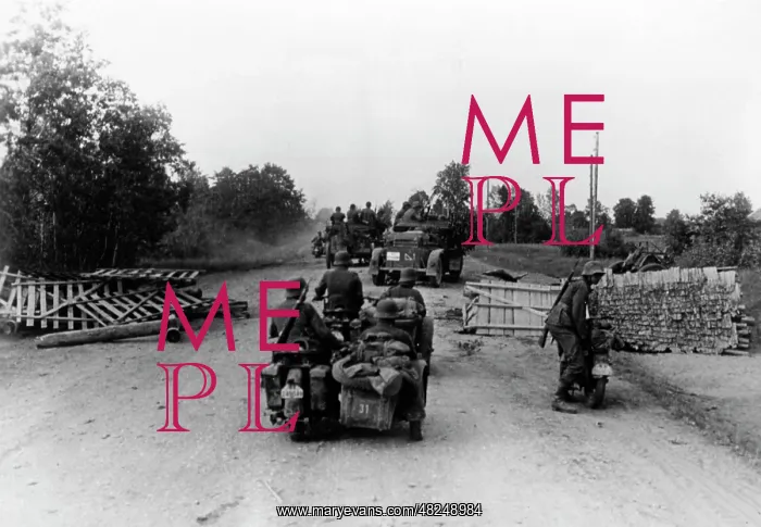 : German motorized troops pass through a roadblock on the : German motorized troops pass through a roadblock on the
