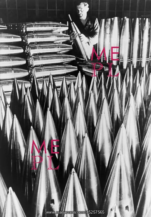 : German munitions worker inspecting large shell : German munitions worker inspecting large shell