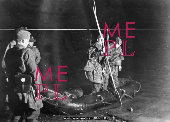 : German paratroopers crossing a river in the night in the : German paratroopers crossing a river in the night in the
