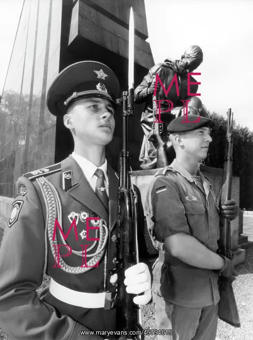 : German and Russian soldier in front of Soviet monument in Be : German and Russian soldier in front of Soviet monument in Be