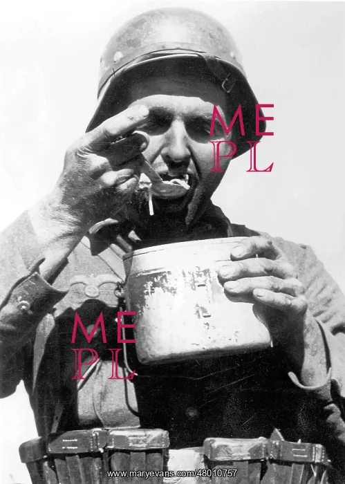 : German soldier eats : German soldier eats