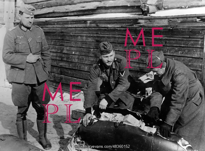 : German soldiers check a provision bomb, 1942 : German soldiers check a provision bomb, 1942