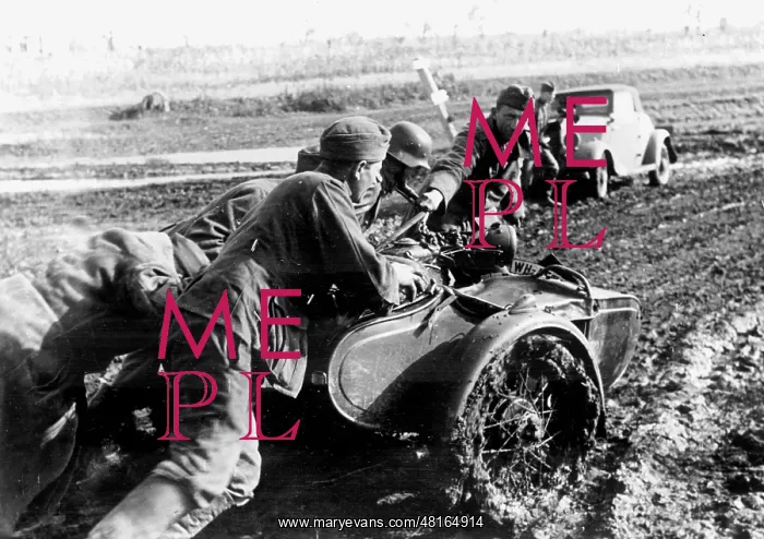 : German soldiers push a motorcycle with a sidecar which stran : German soldiers push a motorcycle with a sidecar which stran