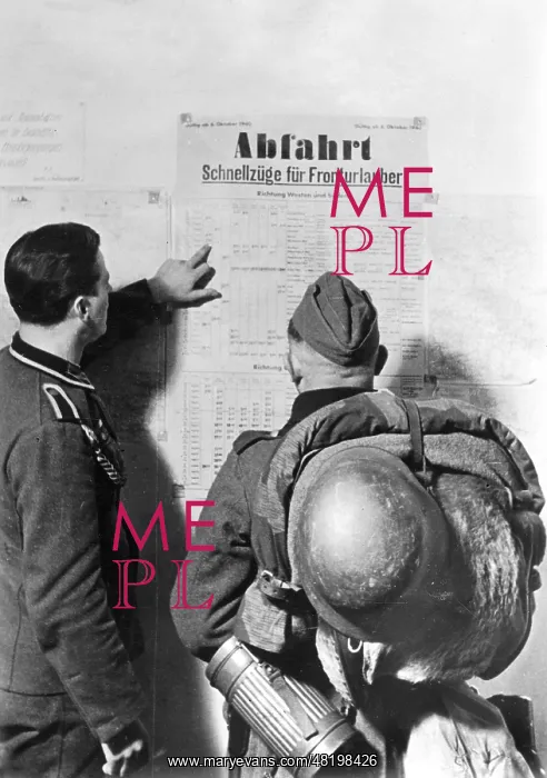 : German soldiers study a train timetable : German soldiers study a train timetable