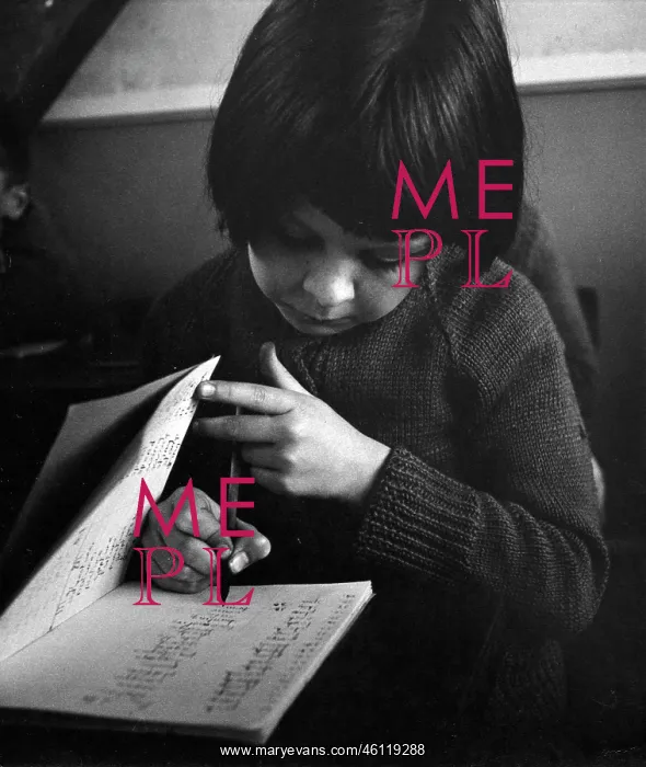 : Girl in a classroom, writing in a school exercise book : Girl in a classroom, writing in a school exercise book