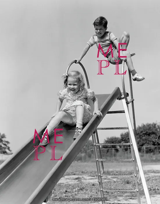 : Girl going down slide boy waiting at top : Girl going down slide boy waiting at top
