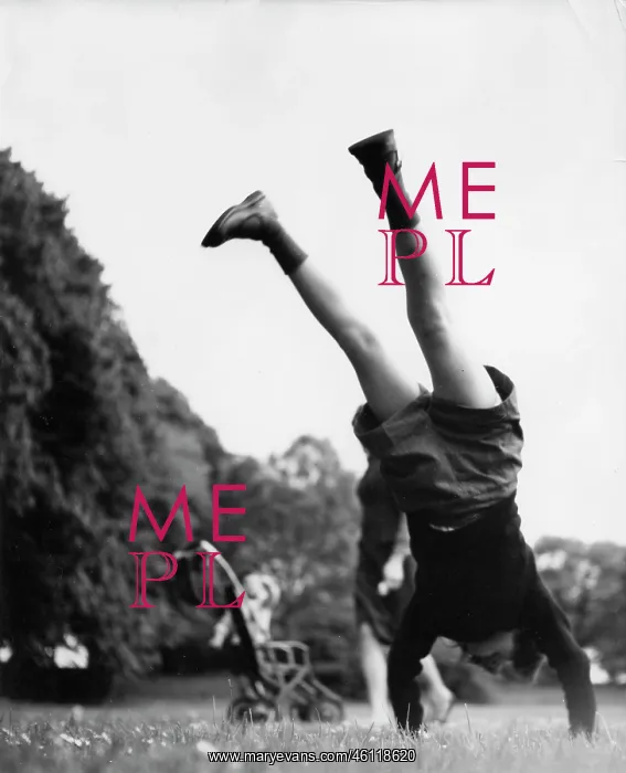 : Girl performing a handstand in a park : Girl performing a handstand in a park