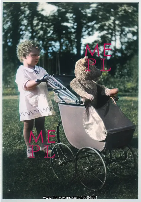 : Girl pushes teddy bear in pram : Girl pushes teddy bear in pram