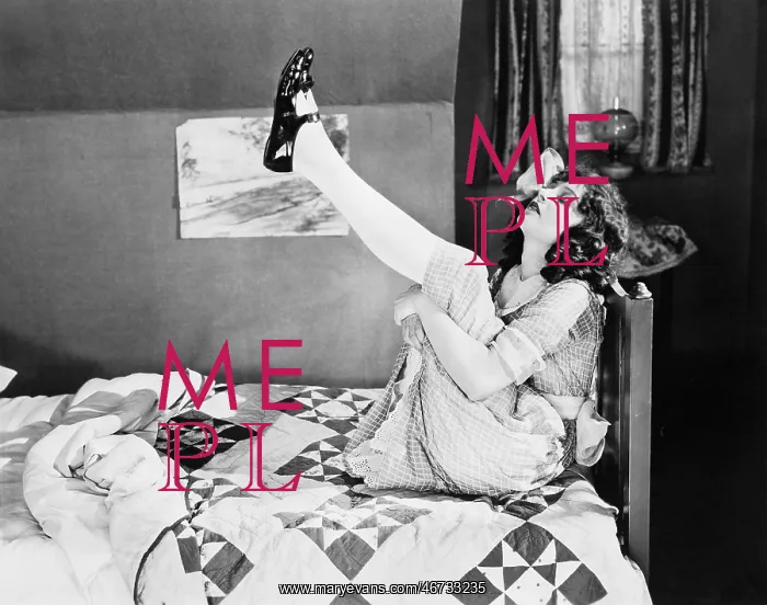 : Girl sitting on a bed, pulling her legs up : Girl sitting on a bed, pulling her legs up