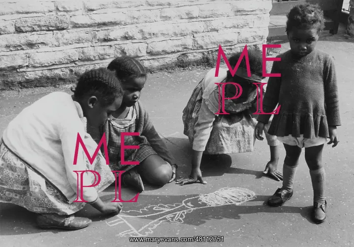 : Four girls chalking on the pavement : Four girls chalking on the pavement