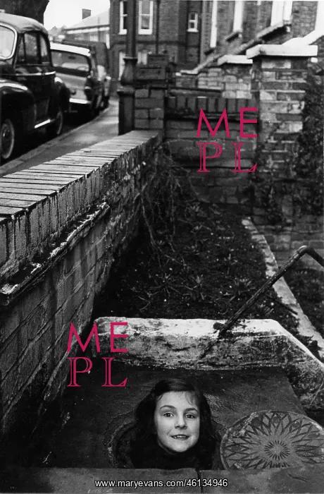 : Girl's head emerging from a coal hole : Girl's head emerging from a coal hole