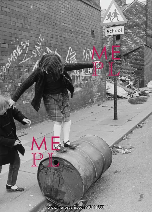 : Two girls playing with an oil drum : Two girls playing with an oil drum