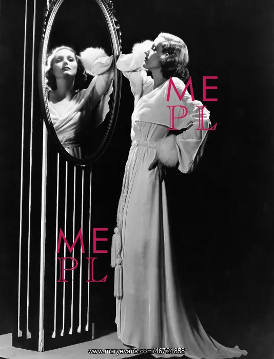 : Glamorous woman looking in mirror : Glamorous woman looking in mirror