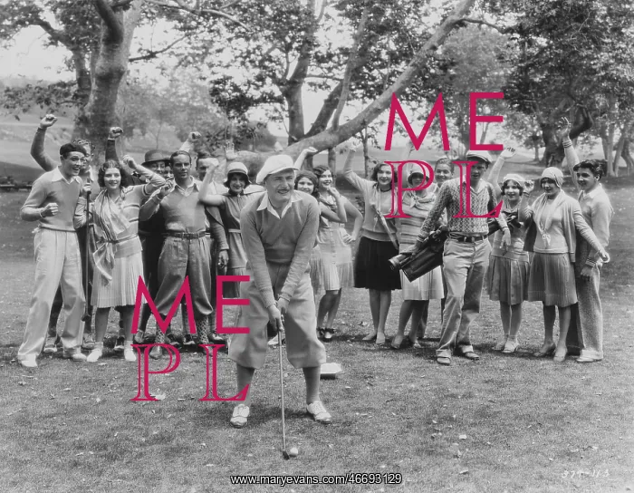 : Golfer teeing off in front of spectators : Golfer teeing off in front of spectators