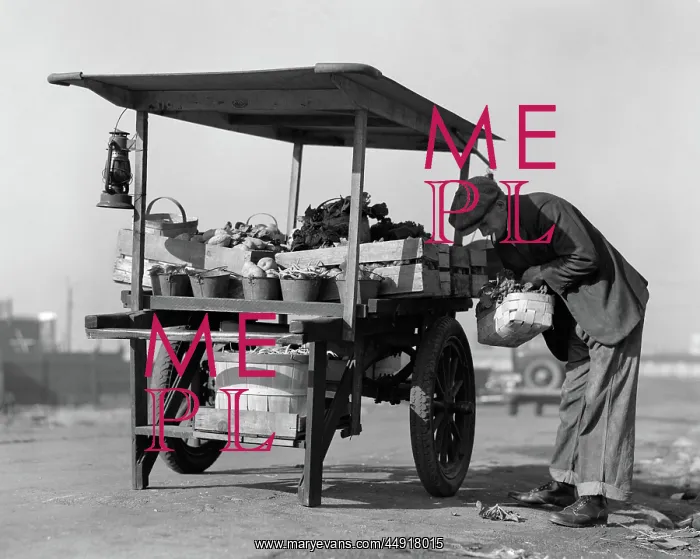  : Grocer outdoors at vegetable cart