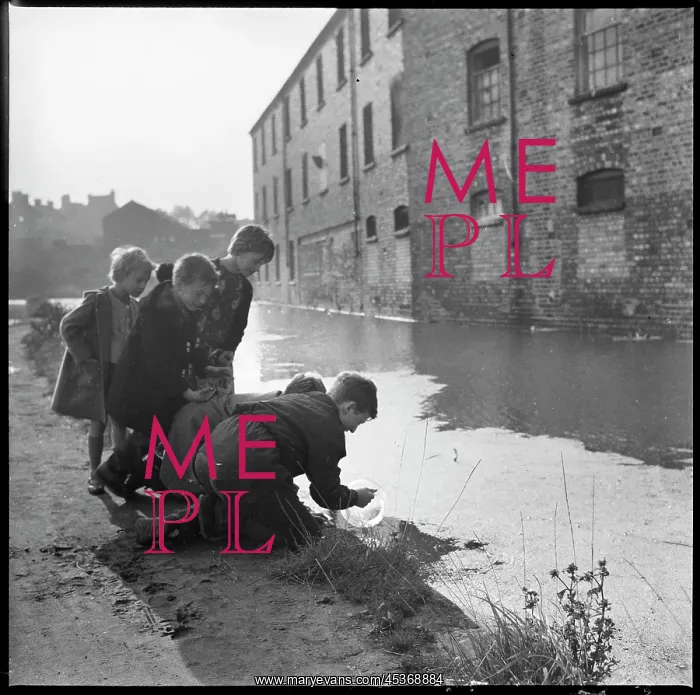 : A group of children using a goldfish bowl to fish : A group of children using a goldfish bowl to fish