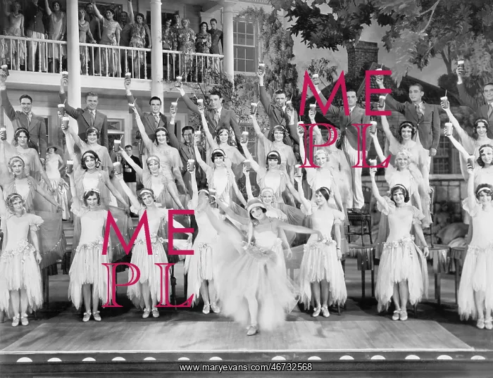 : Group of dancers standing on a stage with their : Group of dancers standing on a stage with their