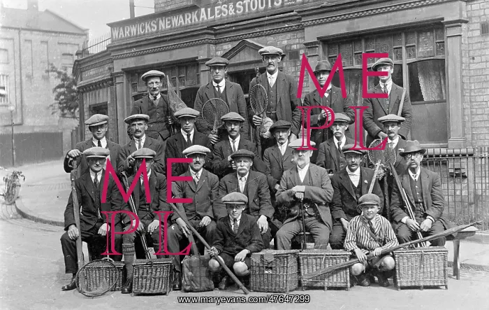 : Group of fishermen with baskets and rods outside a pub : Group of fishermen with baskets and rods outside a pub