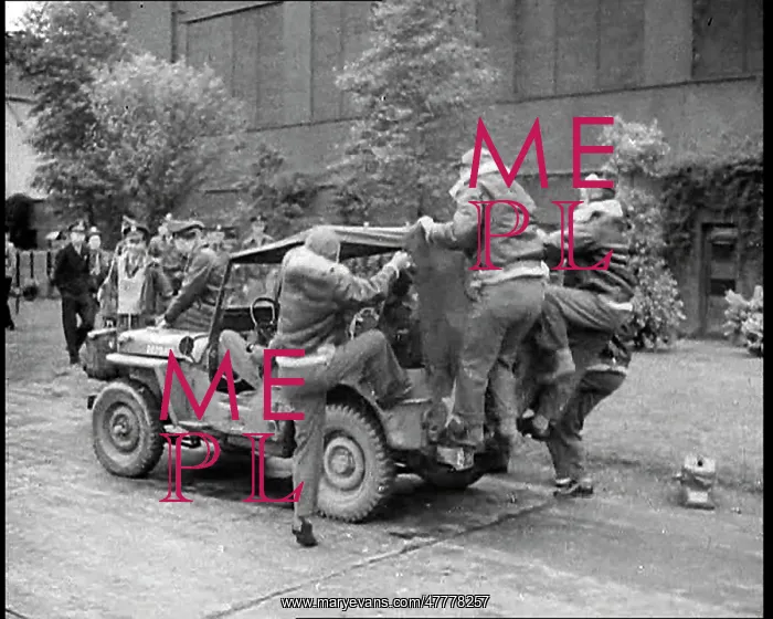 : A Group of Male Pilots Climbing onto a Jeep : A Group of Male Pilots Climbing onto a Jeep