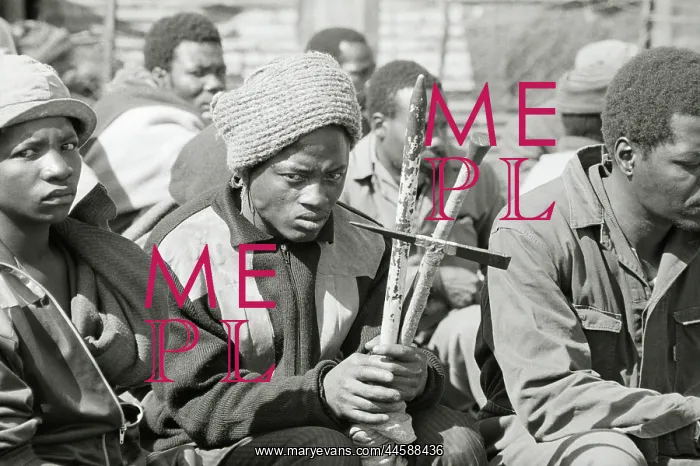 : A group of men, some armed with traditional weapons : A group of men, some armed with traditional weapons