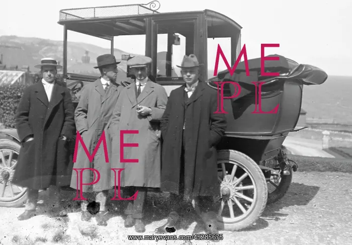 : Group of men by a car : Group of men by a car