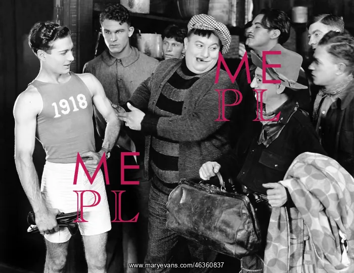 : Group of men looking at an athlete : Group of men looking at an athlete