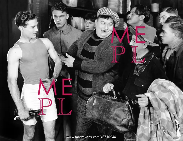 : Group of men looking at an athlete : Group of men looking at an athlete