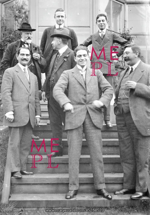 : Group of men on steps of house : Group of men on steps of house