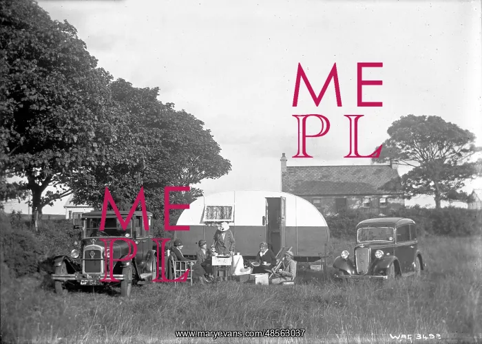 : A group of five people having tea outside a caravan : A group of five people having tea outside a caravan