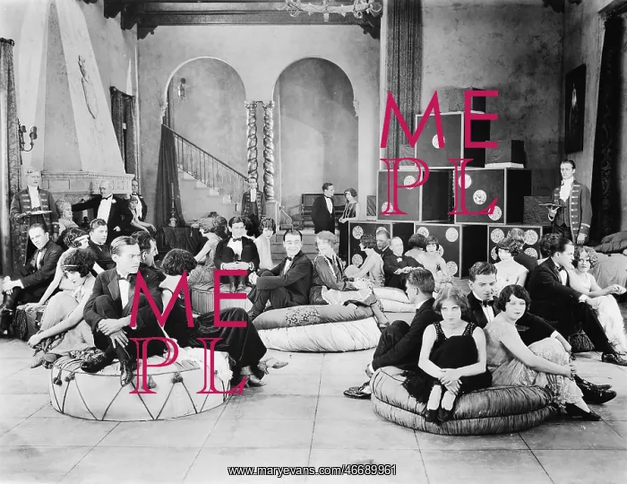 : Group of people sitting on oversized cushions in a hall : Group of people sitting on oversized cushions in a hall