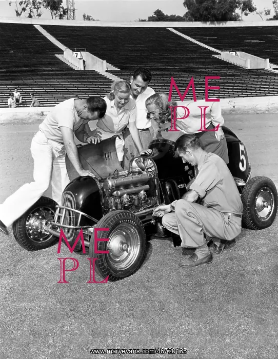 : Group of people working on racecar : Group of people working on racecar