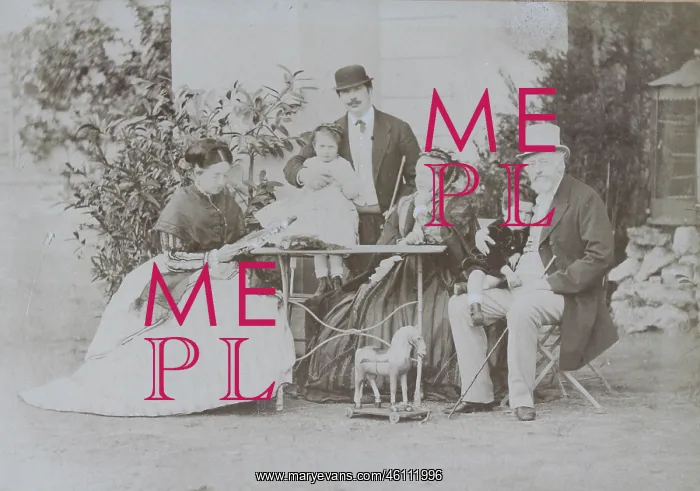 : Group portrait of a family around a garden table : Group portrait of a family around a garden table