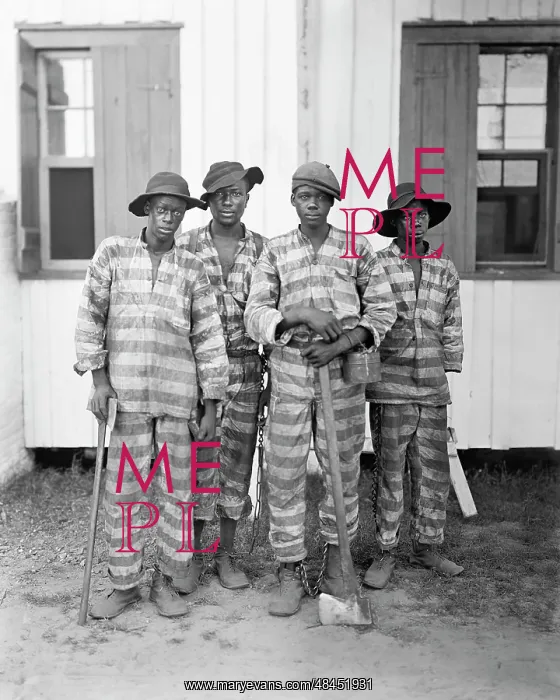 : A group of prisoners chained together in a : A group of prisoners chained together in a
