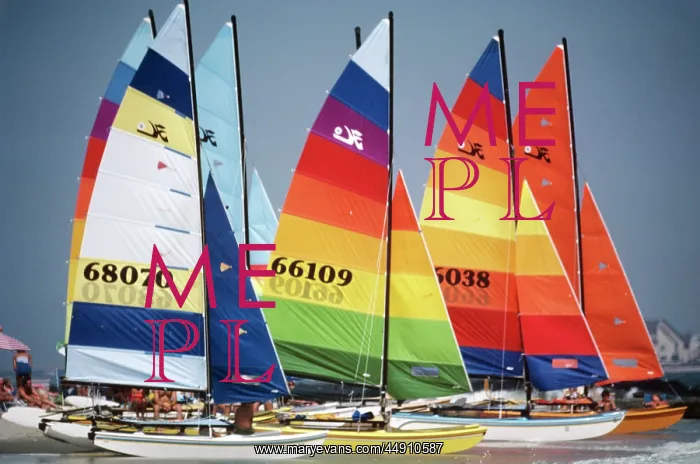 : Group of sailboats with colorfully striped sails : Group of sailboats with colorfully striped sails