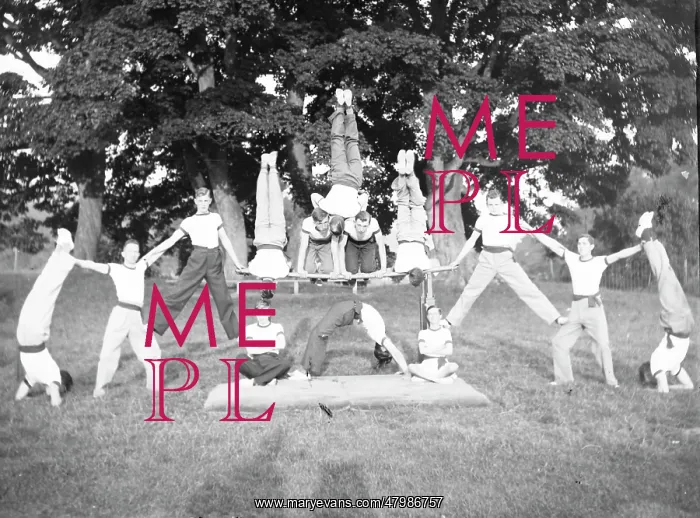 : Group of servicemen doing acrobatics in a field : Group of servicemen doing acrobatics in a field