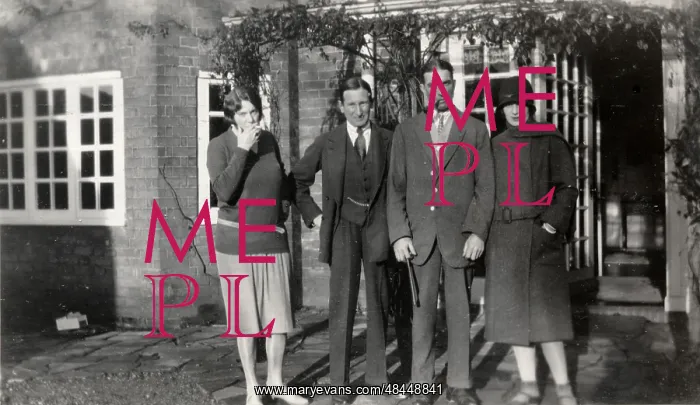  : A group standing in front of a house