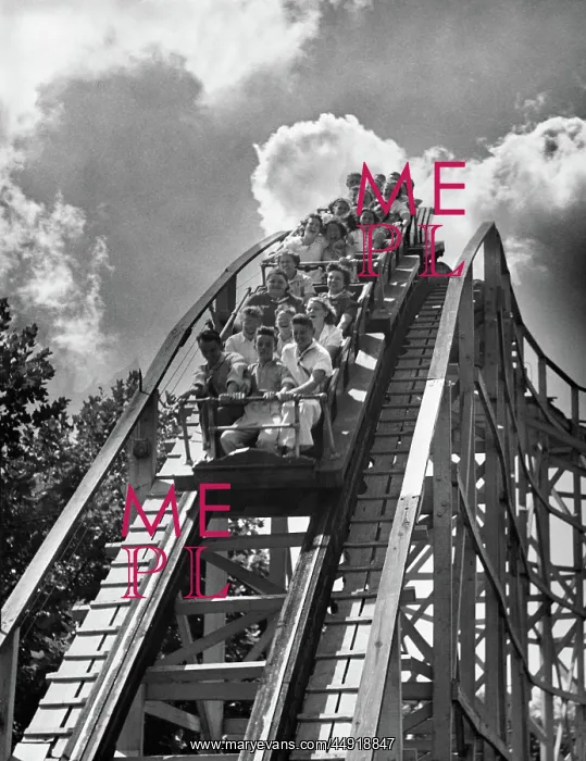 : Group of teens on roller coaster coming down : Group of teens on roller coaster coming down